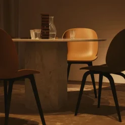 GUBI Chairs*Beetle Plastic chair, Amber , black leg Brown
