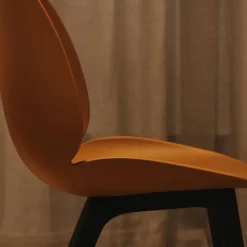 GUBI Chairs*Beetle Plastic chair, Amber , black leg Brown